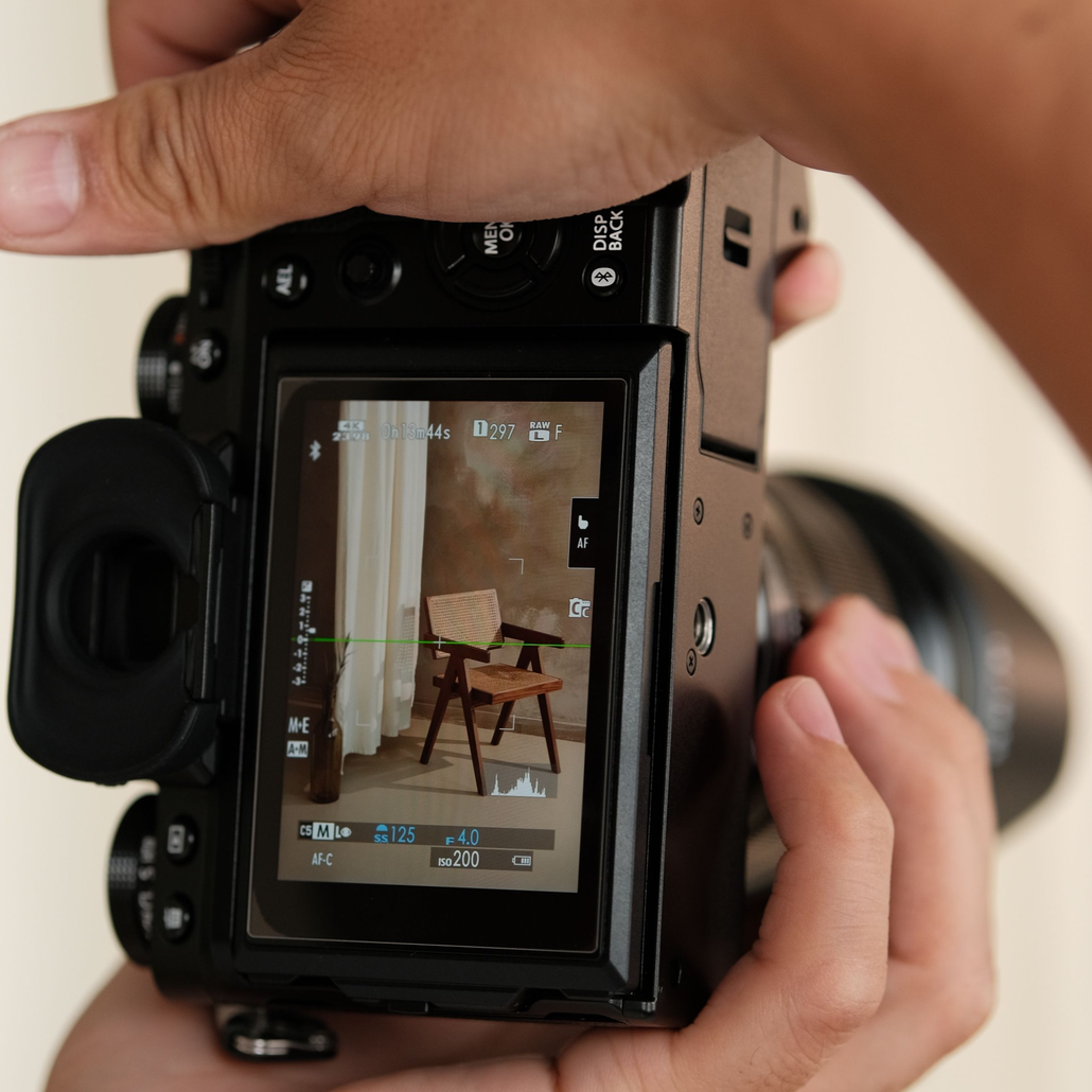 A digital camera capturing an elegant armchair in an indoor setting.